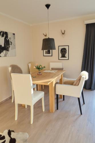 a dining room with a table and two chairs at Willkommen in Ihrem sonnigen Gartenapartment in Kitzbühel