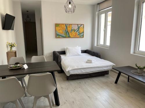 a bedroom with a bed and a table and chairs at TERRA HOMERICA in Chios