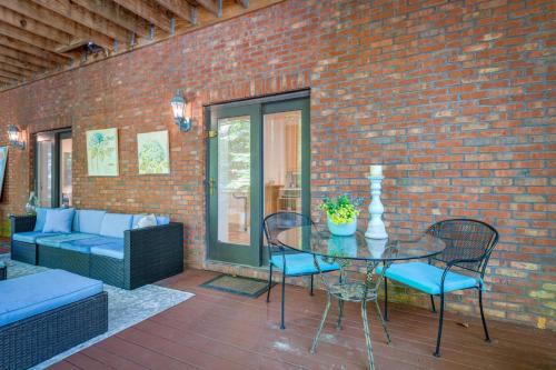a patio with a table and chairs and a brick wall at Cozy Cockeysville Retreat with Furnished Deck in Cockeysville