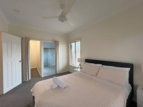 a bedroom with a bed with a white pillow on it at Esperance Bay Retreat in Esperance
