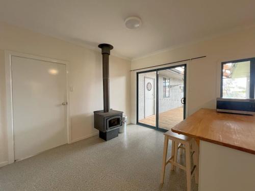a kitchen with a stove in a room with a door at Esperance Bay Retreat in Esperance