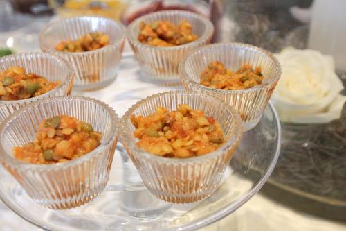 a group of cups of food on a glass plate at Hotel zur Sonne in Rimsting