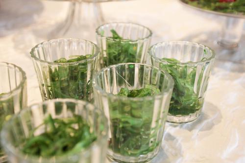 a group of glasses filled with green vegetables on a table at Hotel zur Sonne in Rimsting