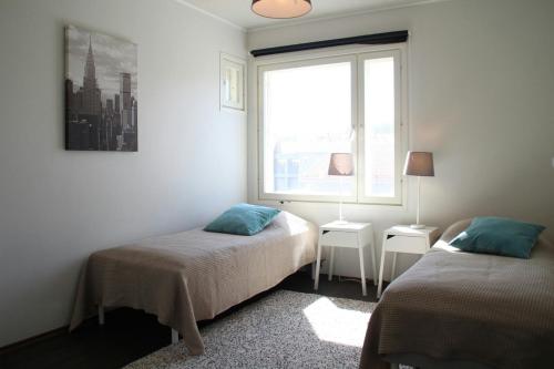 a bedroom with two beds and a window at Spacious Apartment for 8 with Sauna in Kerava