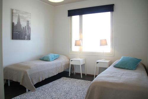 a room with two beds and a window at Spacious Apartment for 8 with Sauna in Kerava