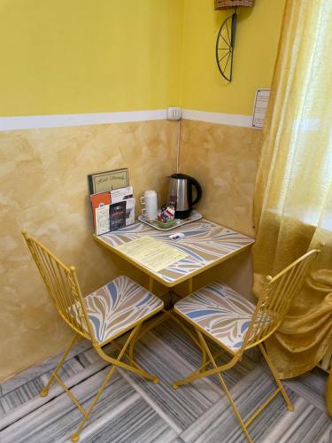 a table and two chairs in a room at Hotel Serenella in Turin