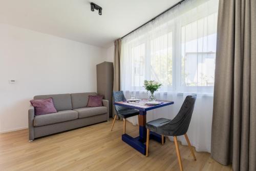 a living room with a table and a couch at Apartamenty Dolina Jawornika in Wisła