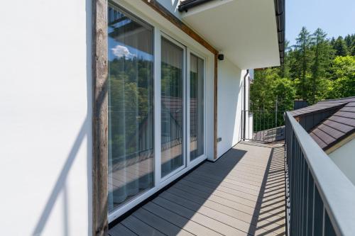 a balcony with sliding glass doors on a house at Apartamenty Dolina Jawornika in Wisła