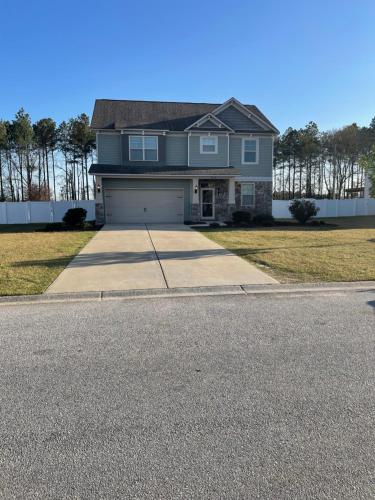 a large house with a garage on a street at Spacious Home Near Shaw in Sumter