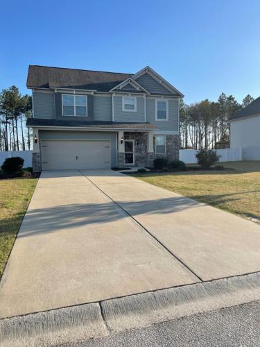 a house with a driveway and a garage at Spacious Home Near Shaw in Sumter