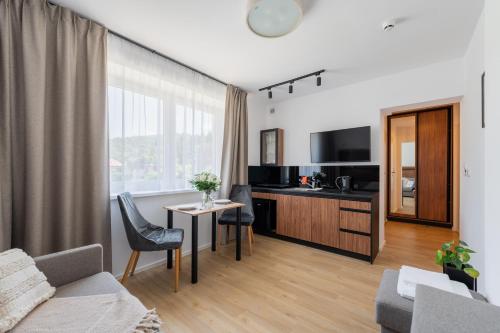 a living room with a couch and a table at Apartamenty Dolina Jawornika in Wisła