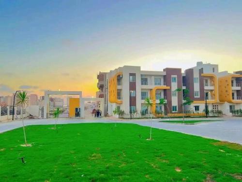a rendering of a building with a green lawn at قريه سورتلاج مرسي مطرح الفيو المميز in Marsa Matruh