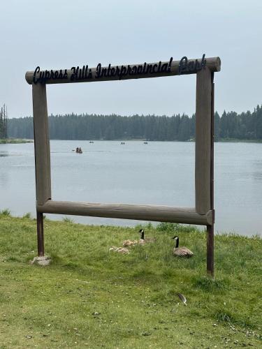 a sign on the side of a body of water at Maple Creek Motor Inn in Maple Creek