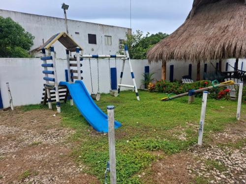 a playground with a slide and a swing set at Finca Villa Gabriela 