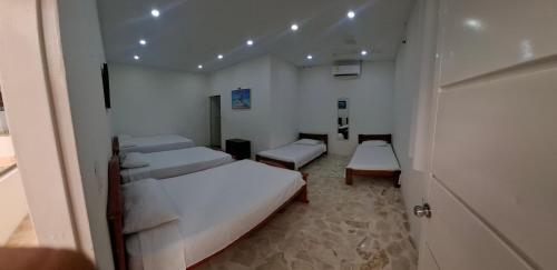 a small room with two beds and a door at Finca Villa Gabriela 