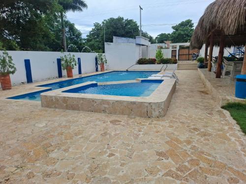 a swimming pool in a yard with a stone floor at Finca Villa Gabriela 