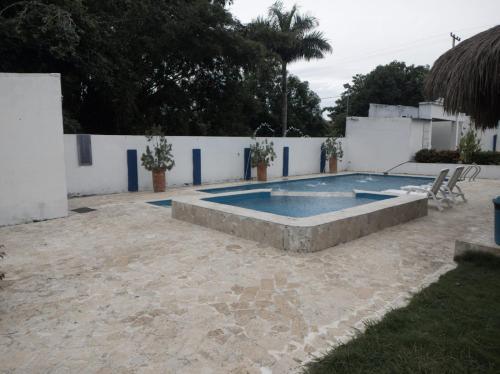 a swimming pool in the middle of a yard at Finca Villa Gabriela 
