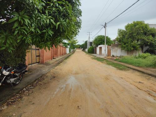 a dirt road with a motorcycle parked on the side at Finca Villa Gabriela 