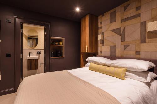 a bedroom with a large bed with white pillows at 3 John's Place Townhouse in Edinburgh