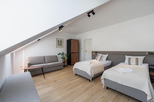 a living room with two beds and a couch at Apartamenty Dolina Jawornika in Wisła