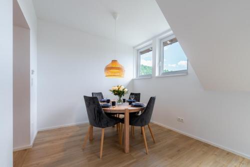 a dining room with a table and chairs at Apartamenty Dolina Jawornika in Wisła
