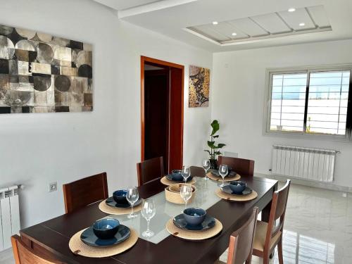 a dining room with a table and chairs at Villa Olivia in El Guecheïne