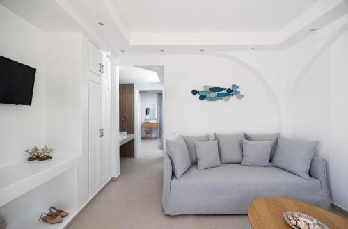 a living room with a couch and a table at calmare collection hotel in Plaka
