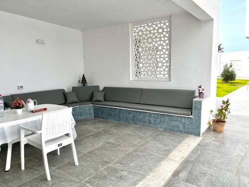 a living room with a couch and a table at Villa Olivia in El Guecheïne