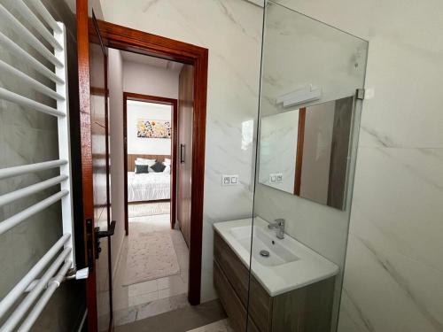 a bathroom with a sink and a mirror at Villa Olivia in El Guecheïne