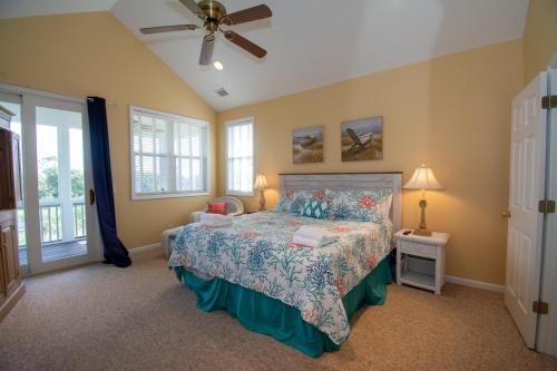 a bedroom with a bed and a ceiling fan at 83 Ocean Creek Blvd in Fripp Island