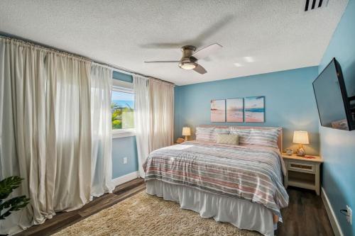 a bedroom with a bed and a window at Luxury heated-pool home blocks from the beach in Tarpon Springs