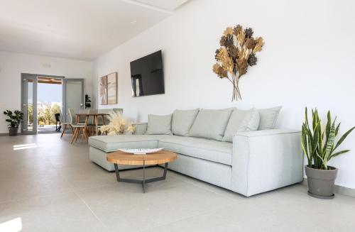 a living room with a white couch and a table at calmare collection hotel in Plaka
