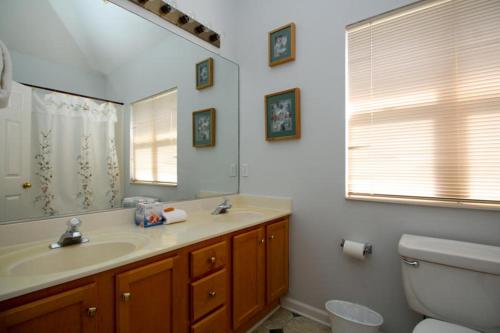 a bathroom with a sink and a toilet and a mirror at 37 Davis Love in Fripp Island