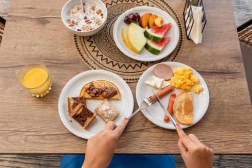 a table with two plates of breakfast food on it at Lofos Luxury Living in Stavros
