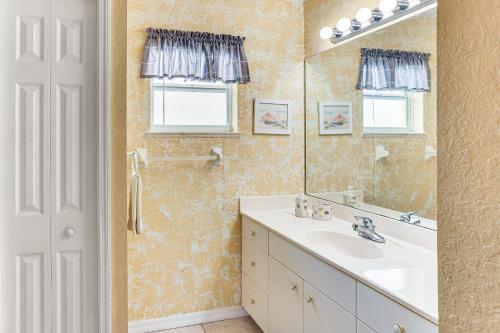 a bathroom with a sink and a mirror at 5 Mi to Sebring Intl Raceway Canal-View Retreat! in Sebring