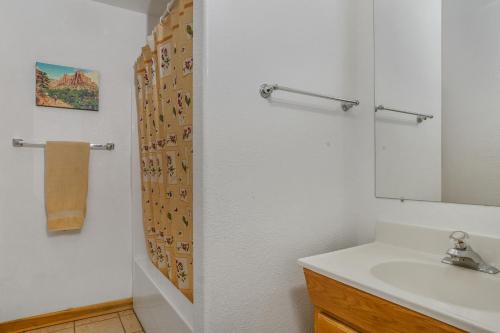 a bathroom with a sink and a shower curtain at Ranchette Ponderosa - The Timpanogos #1 at Wind Walker Homestead in Spring City