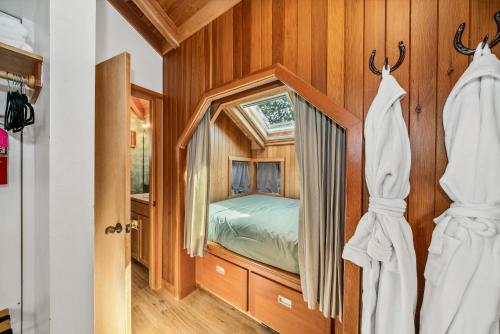 a bedroom with a bed in a room with a window at The Inn at Manzanita in Manzanita