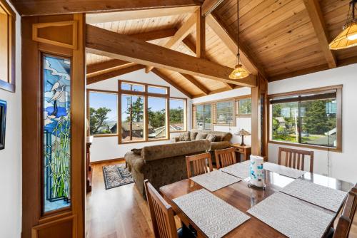 a dining room with a table and a couch at The Inn at Manzanita in Manzanita