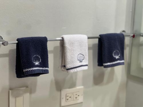 three towels hanging on a towel rack in a bathroom at Tropical Views - Luxury Live #The Best Views #Walk to The Beach in San Juan del Sur
