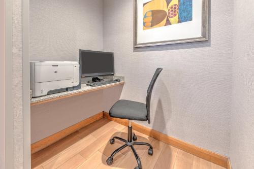a room with a desk with a computer and a chair at Hampton Inn Phoenix Midtown Downtown Area in Phoenix