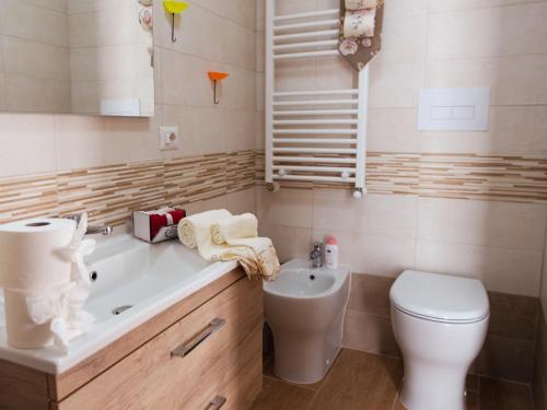 a bathroom with a toilet and a sink at La casa di Zio Felice in Francavilla in Sinni
