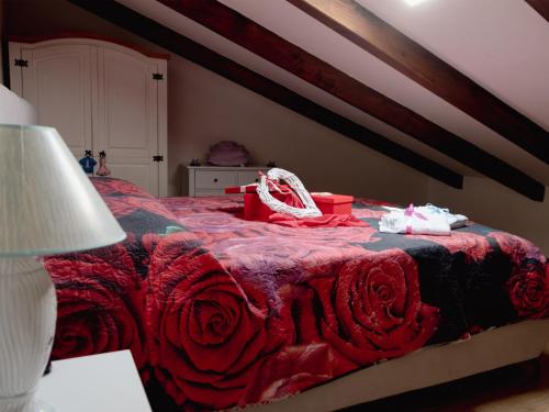 a bedroom with a bed with a red comforter at La casa di Zio Felice in Francavilla in Sinni