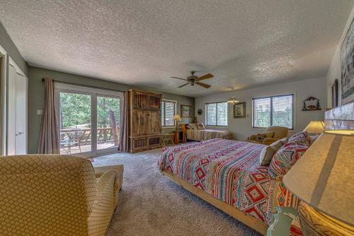 a bedroom with a bed and a balcony at Rustic Alto Cabin with Hot Tub, Deck and Fireplace! in Alto
