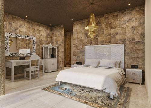 a bedroom with a bed and a vanity and a mirror at Shah Palace Zanzibar - All Suites in Matemwe