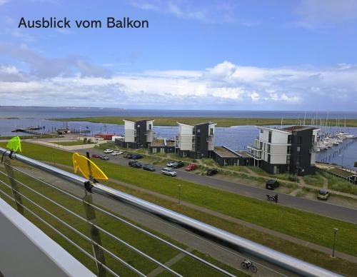 a view of a highway with buildings and a harbor at Deichblick in Wendtorf
