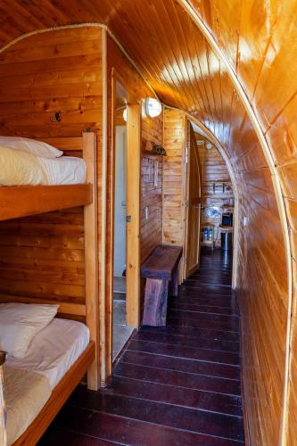 a hallway in a log cabin with two bunk beds at Refugio Piedra Parada in Tona
