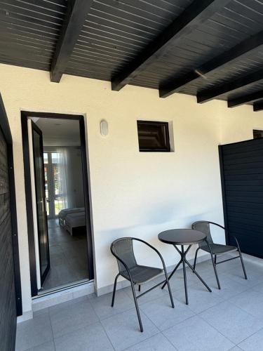 a patio with two chairs and a table on a patio at Casa WEEK Dunare in Baziaş