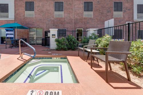 a patio with a pool and chairs and a building at Hampton Inn Phoenix Midtown Downtown Area in Phoenix