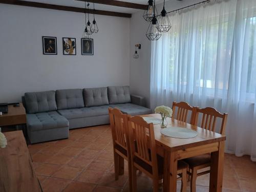 a living room with a table and chairs and a couch at Chata Pod Różą in Lędzin