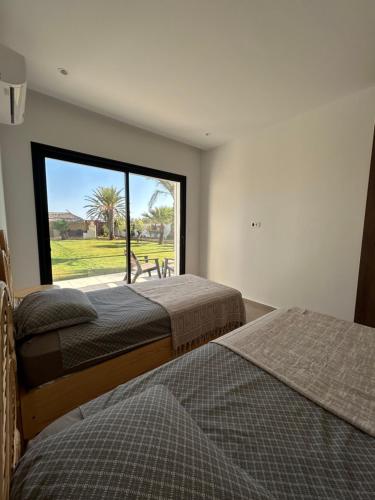 Ένα ή περισσότερα κρεβάτια σε δωμάτιο στο Villa Mimi Djerba